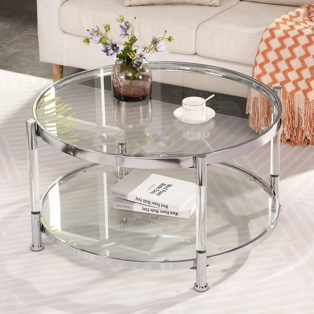 A round coffee table with a metal frame, the surface is made of chrome-plated acrylic glass.